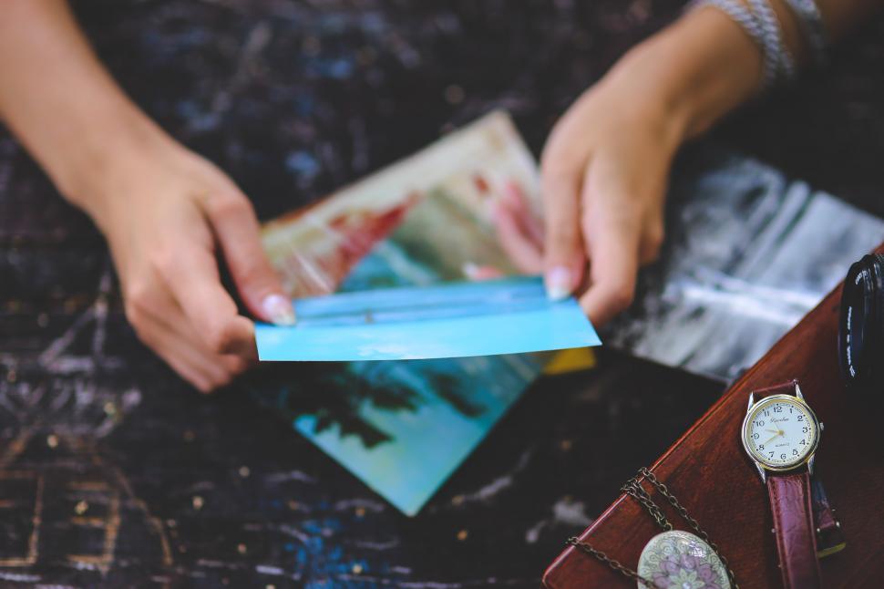 hands on lap holding letter with keepsake box in foreground
